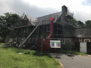 Kingsley Roofing providing safe access for roof works via a full height scaffold to the property and fencing to protect the public from the works machinery and materials.